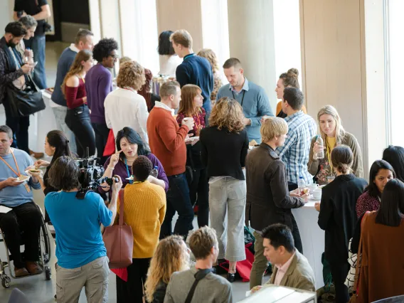 A group of people standing and talking 