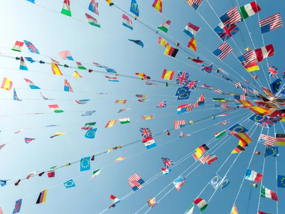 World flags hanging on strings that gather at a central point.