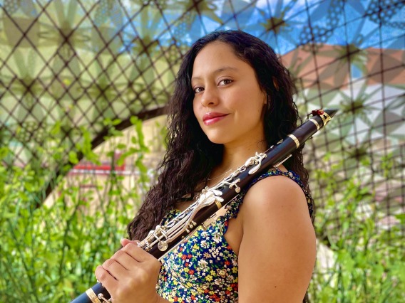 Portrait of Gloria Orozco holding a clarinet.