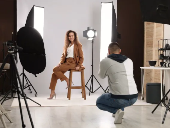 An Image of a woman getting a professional photo taken in a studio