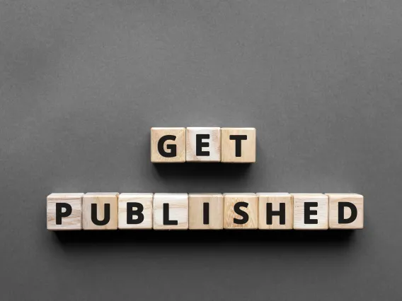 Wood block letters spelling out "Get Published" on a gray background.