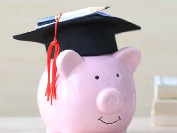 Image of a piggy bank with a graduation cap on.