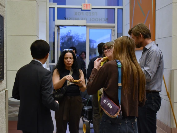 Photo of Beihua Guo and audience members associated with the School of Art at the reception. 