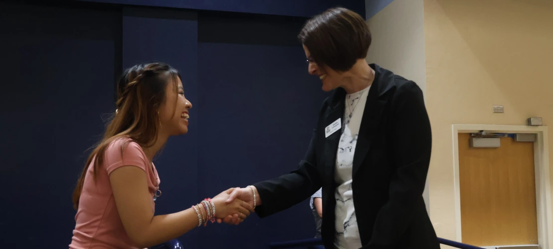 McNair Scholar, Amanda, shaking hands with Dean Limesand
