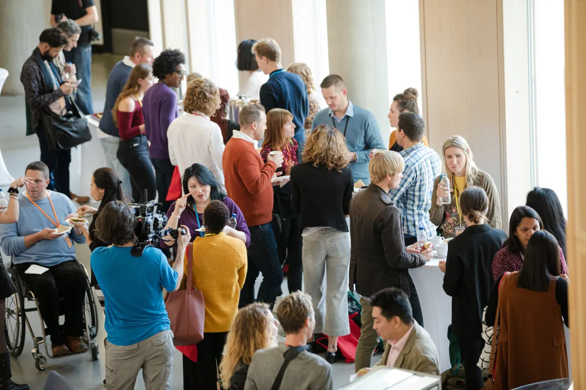 A group of people standing and talking 