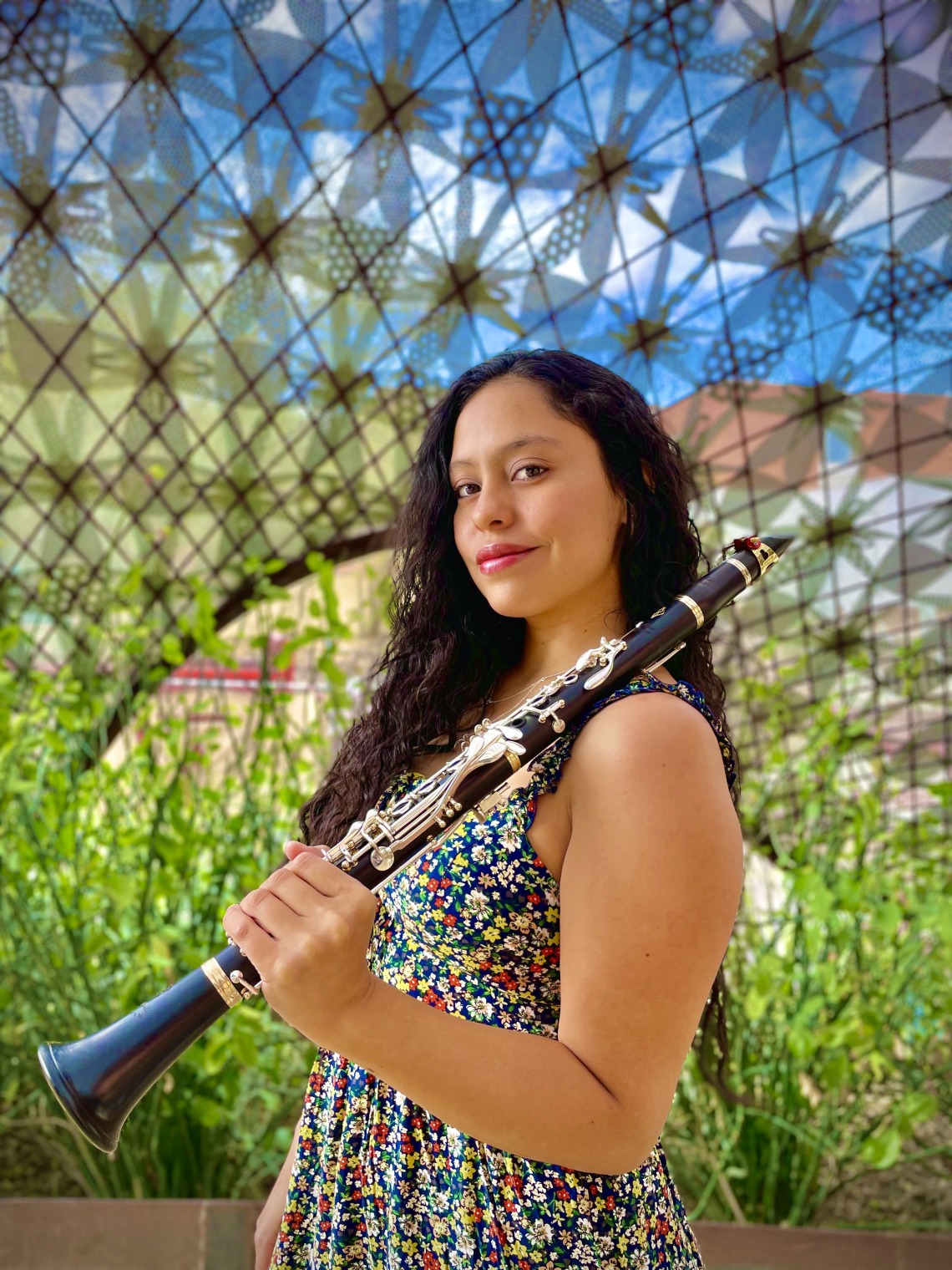 Portrait of Gloria Orozco holding a clarinet.