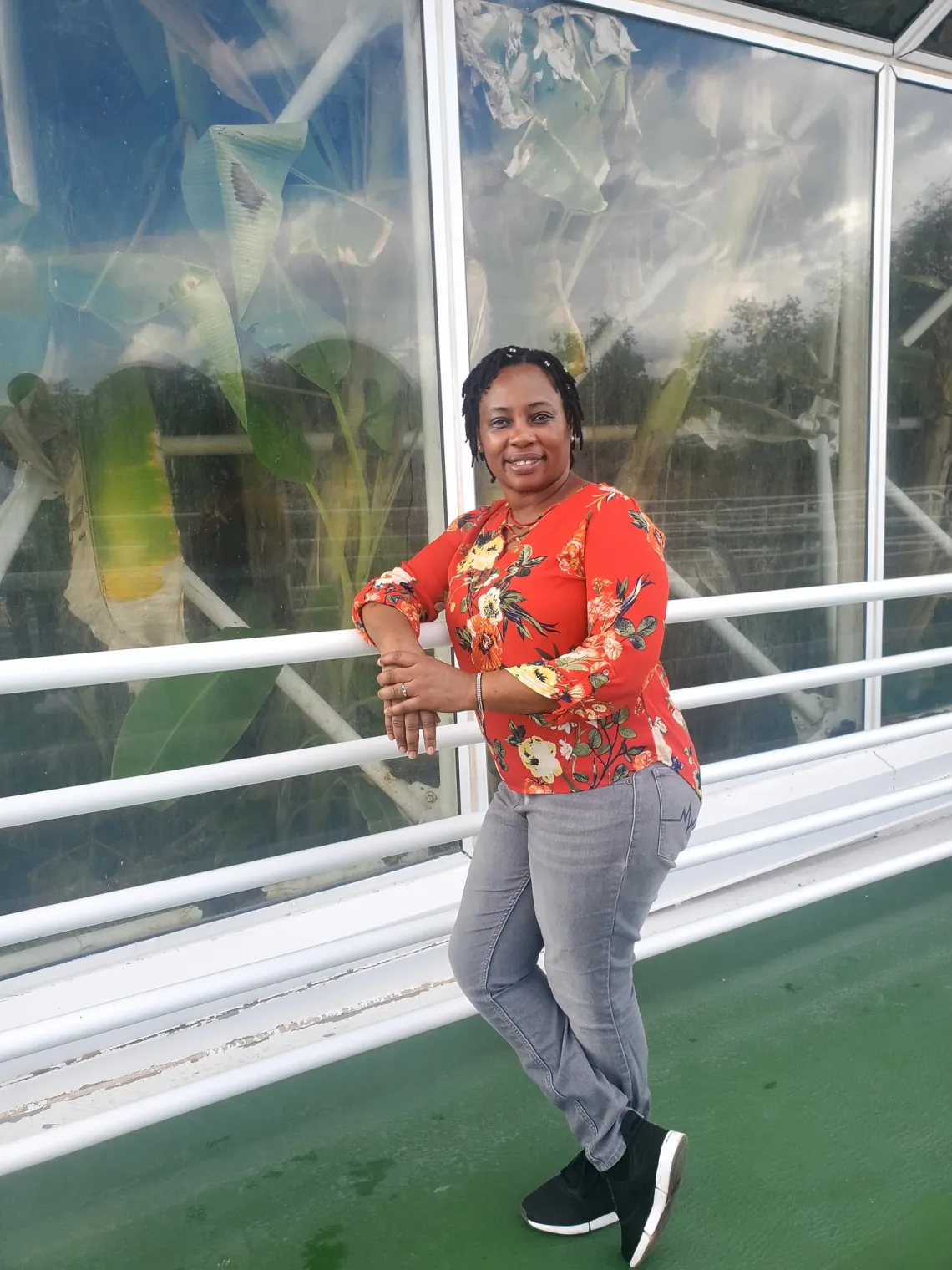 Lucy Mugambi standing in front of a building.