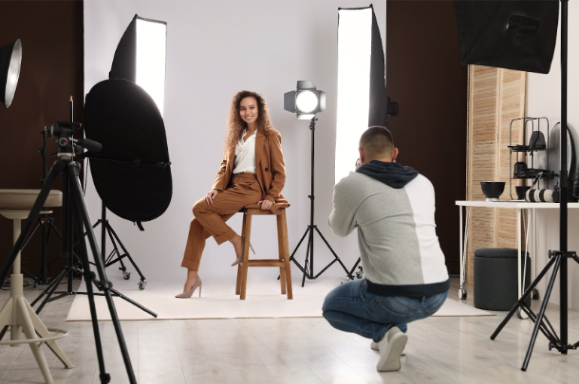 An Image of a woman getting a professional photo taken in a studio