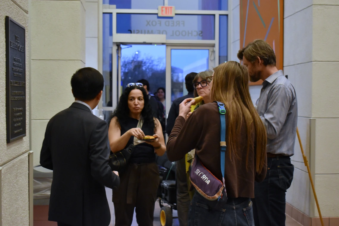 Photo of Beihua Guo and audience members associated with the School of Art at the reception. 