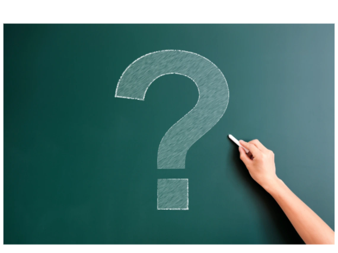question mark drawn in chalk on a green chalkboard