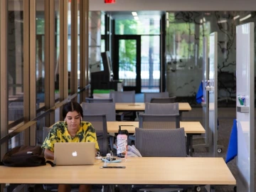 student working on laptop at table
