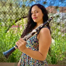 Gloria Orozco Dorado posing with a clarinet.