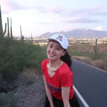 Jiayi Wang smiling at the camera while on a hike