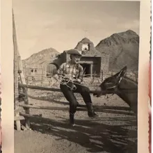 A photo of a western christmas card with Michaela and a horse