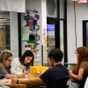 Students gathered around a table working on crafts